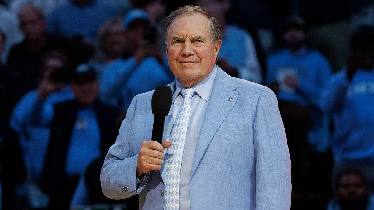 Jordon Hudson’s Playful Dig at Bill Belichick’s Blue Suit in Carolina Playoff Sea of Red