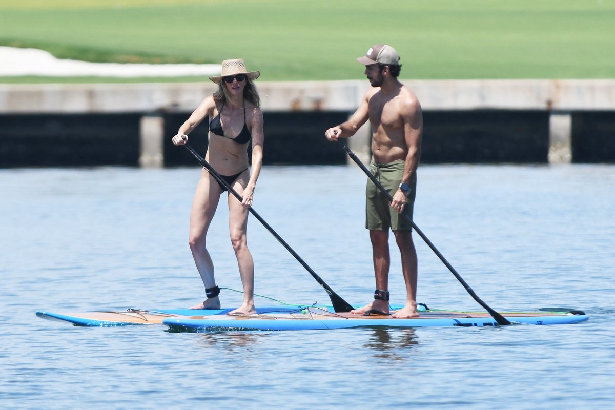 Gisele Bündchen Glows in White Swimsuit During Florida Paddleboard Session